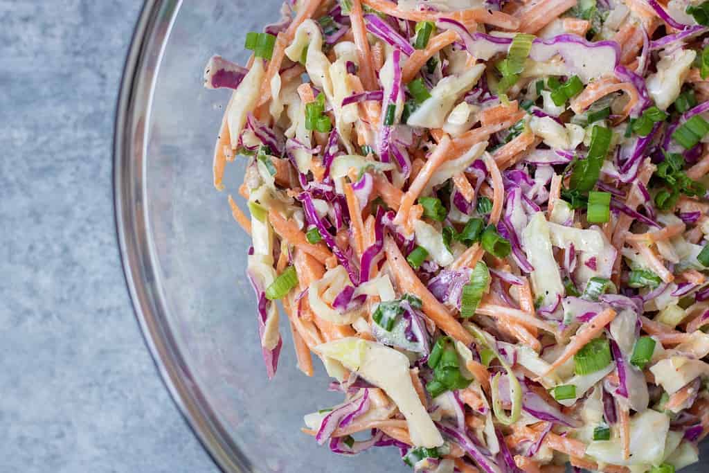 Asian style coleslaw made with shredded purple cabbage, shredded carrots, sriracha mayo, soy sauce and lime. It’s served with Asian turkey burgers