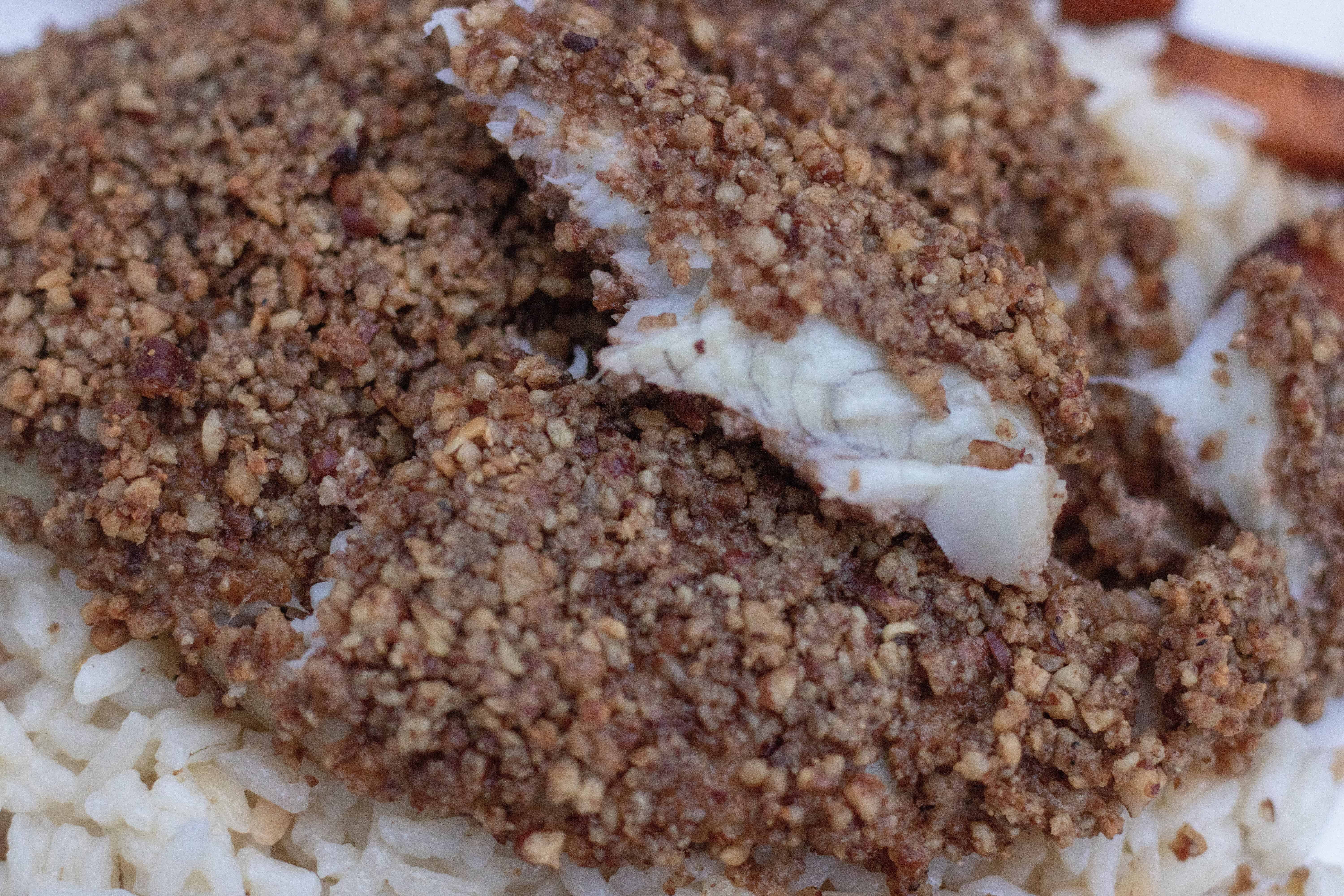 flaky and moist white fish is crusted with toasted pecans and parmesan cheese. It's served over rice pilaf.