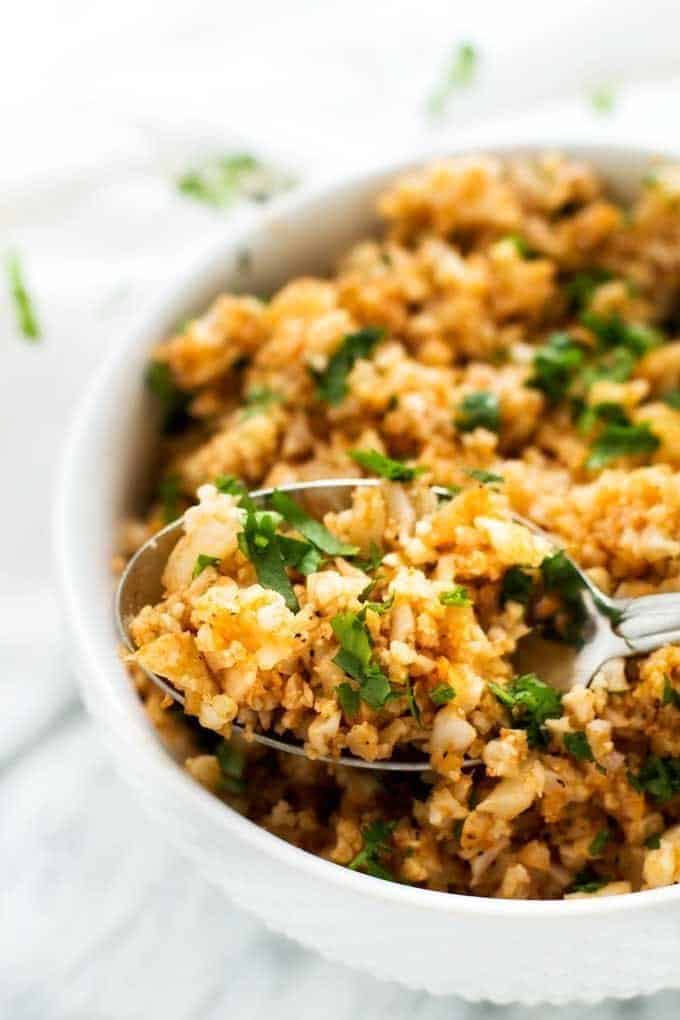 Spanish cauliflower rice is an easy to make side dish without the guilt! Gluten free, low calorie, and Keto friendly!