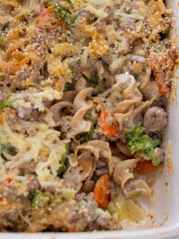 Creamy noodle casserole with broccoli, carrots, cream cheese. Its topped with panko bread crumb. You can see the creamy noodles.
